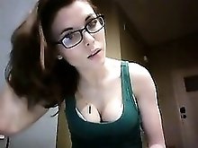 Geeky brunette displays her delicious cleavage in a green t